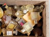 a wooden box filled with bottles of perfume and bottles of perfume