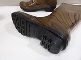 pair of brown rain boots with black soles sitting on a white surface