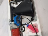 a box with a horn, a drill, and other tools in it