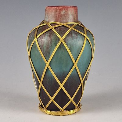 a vase that has a green and blue design on it