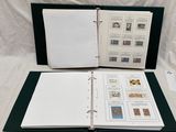 an open book with stamps on it sitting on top of a table