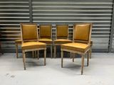 set of four chairs with leather upholstered backrests