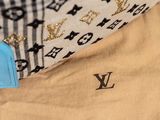 a blue tag on a tan shirt with a black and white checkered pattern