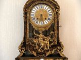 a clock hanging on the wall with a bird on it