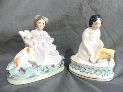 two figurines of a woman and a child sitting on a boat