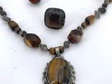 necklace, bracelet, and ring with a tiger eye stone pendant