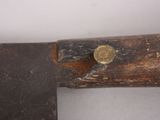 a close up of a piece of wood with a hammer on it