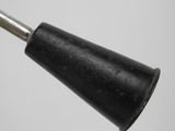 a close up of a black lamp on a white surface