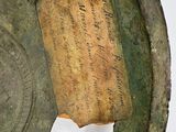 a close up of a metal object with writing on it
