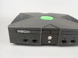 a close up of a black xbox game console