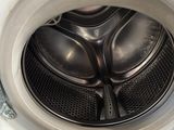 a close up view of a washing machine with the door open