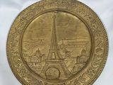 gold plate with a picture of the eiffel tower on it