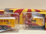 two yellow and red toy trucks in a box