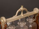 an old fashioned glass decanter on a wooden stand