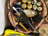 a basket full of batteries and other items on the floor