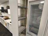 an open refrigerator in the middle of a kitchen