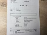 a paper on the table with a picture of a man ' s name on it