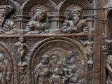 an old wooden chest with carvings of people and animals on it