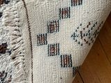 a close up of a rug on a wooden floor with a wooden floor
