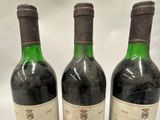 three bottles of wine sitting on top of a table next to each other