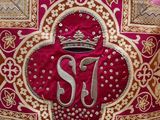 a close up of a cross with a crown on top of it