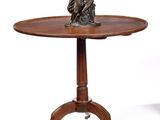 an antique table with a statue of a man on top of it