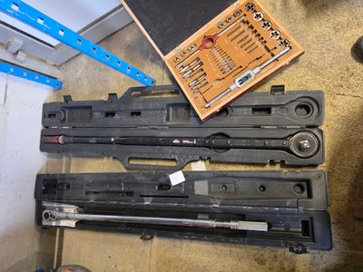 une boîte à outils posée par terre à côté d'une paire de ciseaux
