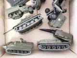 a box full of toy army vehicles and a toy tank