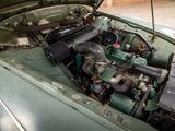 a green car with an engine in the trunk