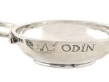 an old silver bowl with a handle on a white background