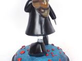 figurine of a woman holding a cat on a blue base