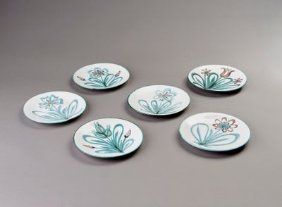 six small plates with flowers on them are sitting on a table