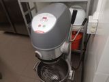 a mixer in the kitchen with a whisk inside of it