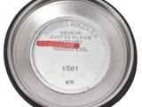 a close up of a metal container with a red marker on it