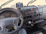 a dashboard and steering wheel of a vehicle with a gps device on the dashboard