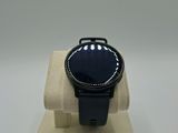 an image of a smart watch sitting on a stand on a white surface