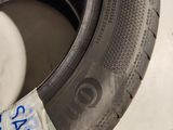 someone is holding a tire that has a sticker on it