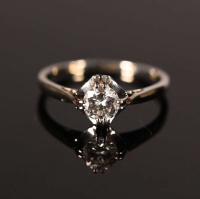 a close up of a diamond ring on a black surface