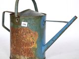a rusty watering can with a tag on it