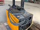 a yellow machine that is sitting on a pallet