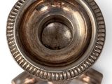 a metal object that is sitting on a white surface