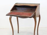 an old wooden desk with a drawer on top of it