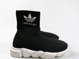 black and white sneakers with white soles and a logo on the side
