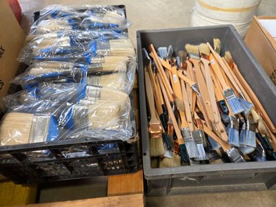 two bins of paint brushes sitting next to each other