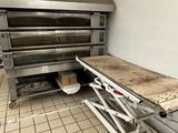 une photo d'une cuisine avec une table au milieu