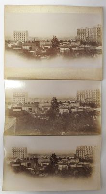two old black and white photos of a city with buildings