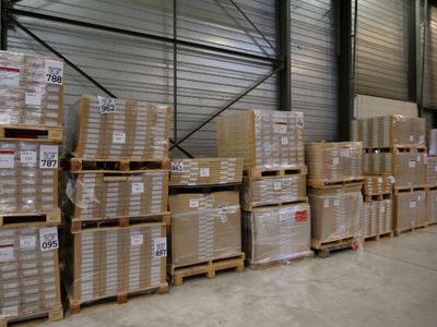 a lot of boxes stacked on pallets in a warehouse