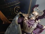 a figurine of a man dressed in armor and holding a sword