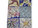 several different colored tiles with designs on them on a white surface