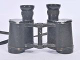 an old pair of binoculars sitting on top of a white surface